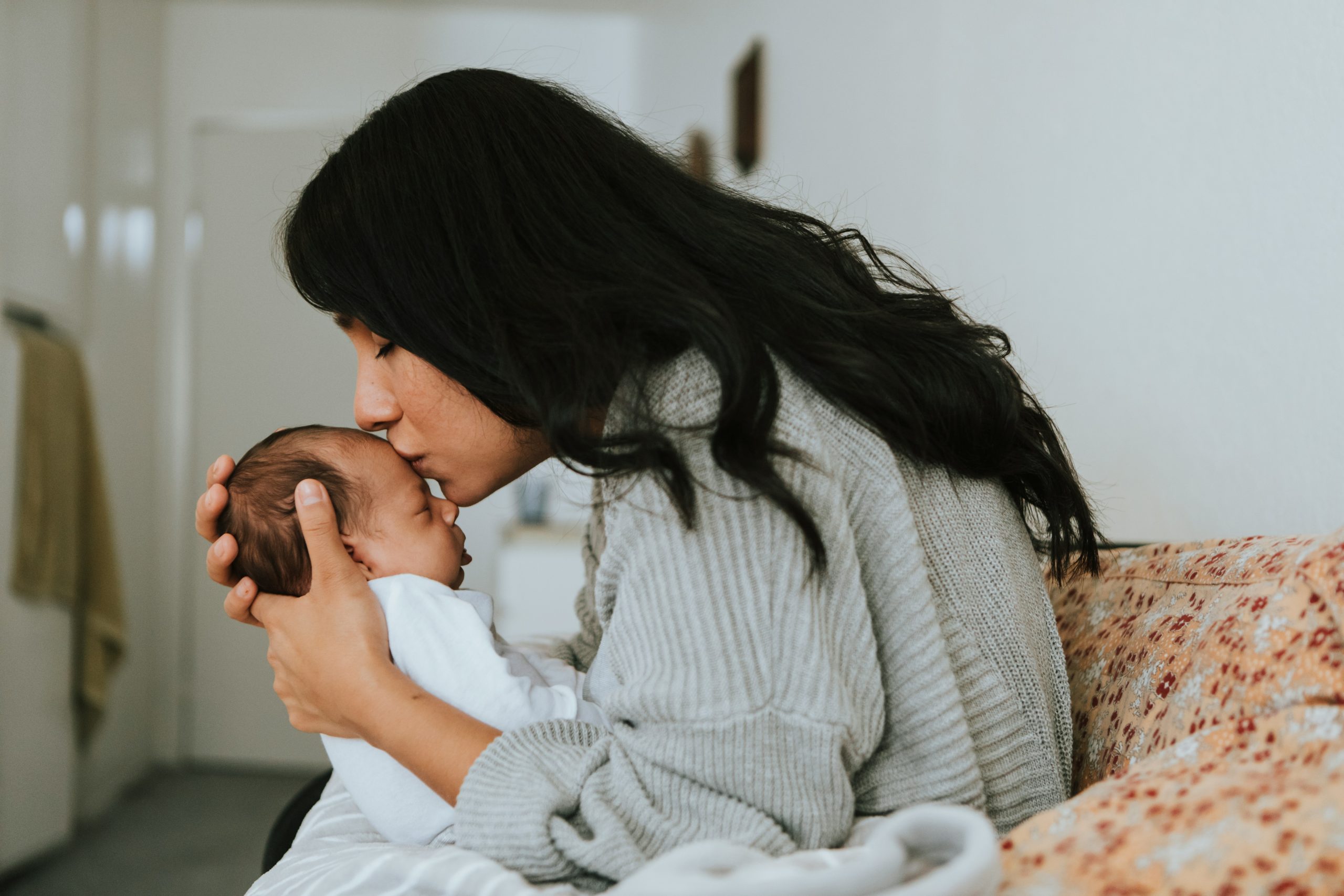 woman kissing baby