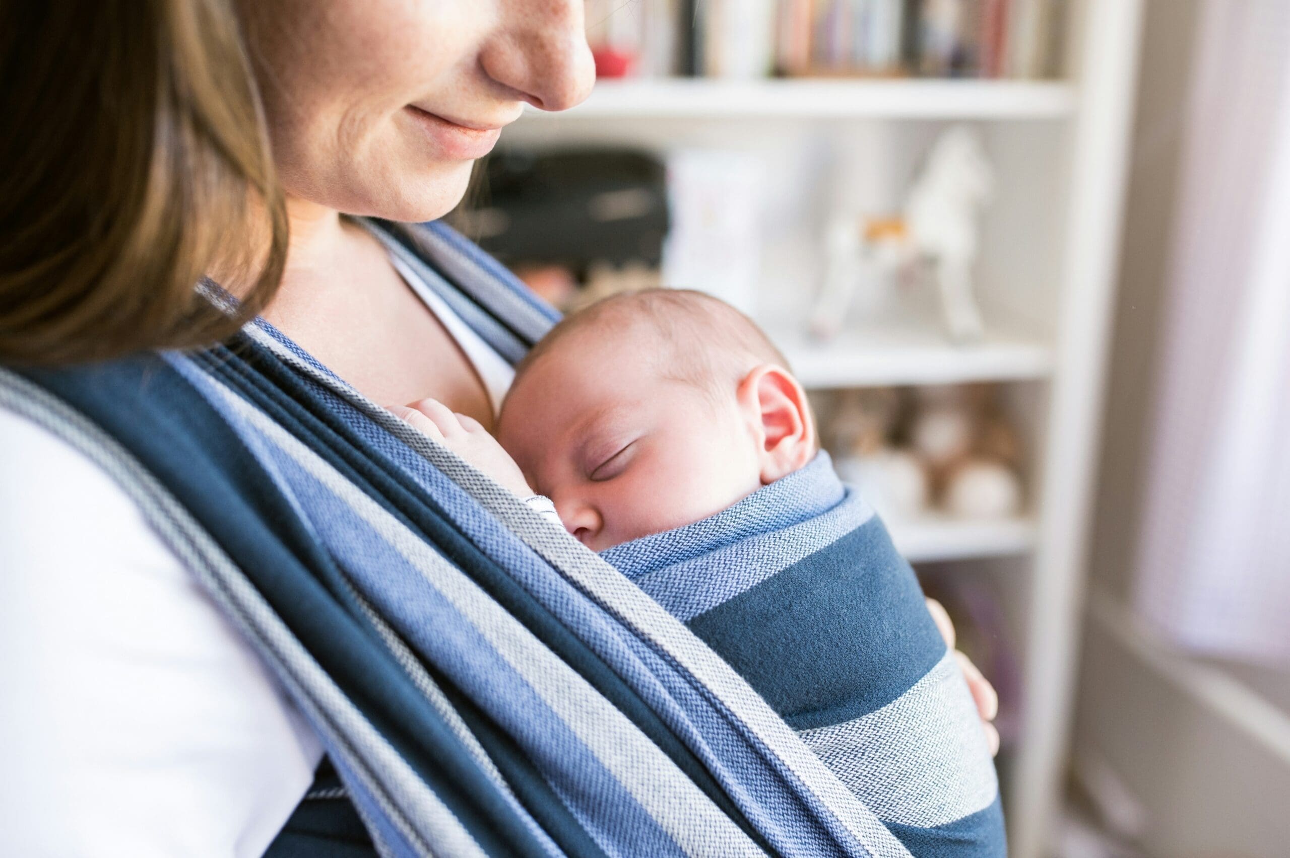 mother with baby asleep in carrier